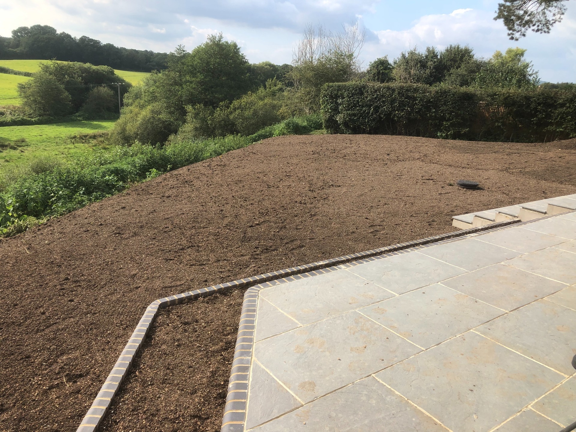 A patio and landscaping project in West Sussex nearing completion