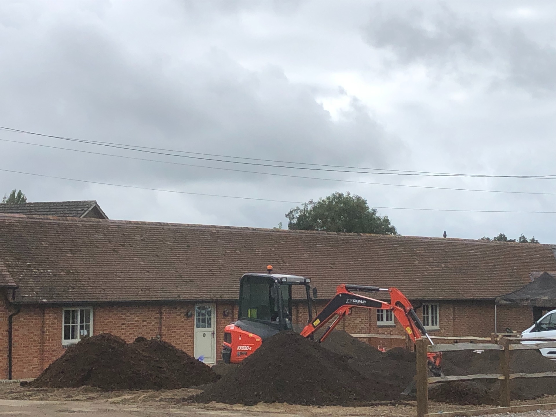 A K Crumley Construction mini digger hard at work on a building project in West Sussex.